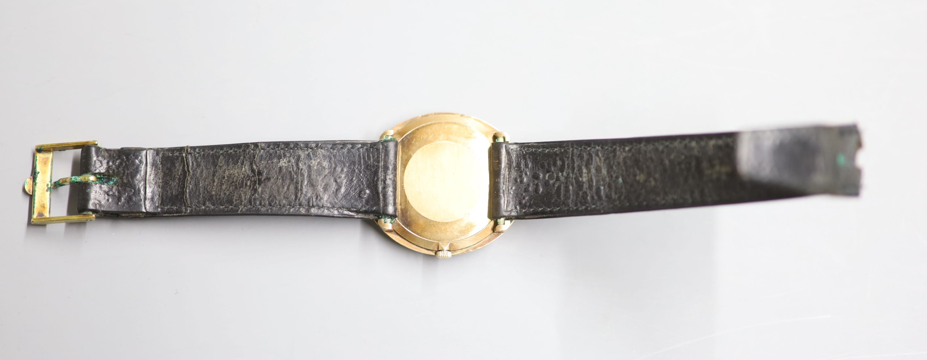 A gentlemans 9ct gold Omega manual wind dress wrist watch, on associated damaged leather strap,